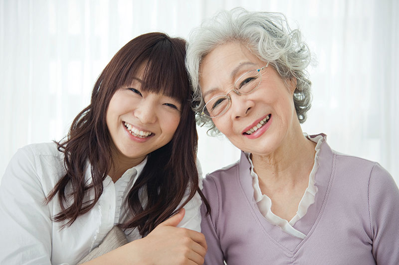 Adult mother and daughter smiling together
