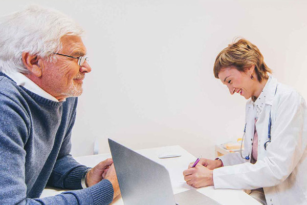 I provider is taking notes while chatting with a patient