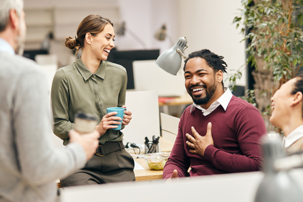 A group of coworkers sharing a laugh in an office
