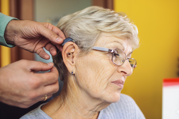 A woman being fitted with hearing aids