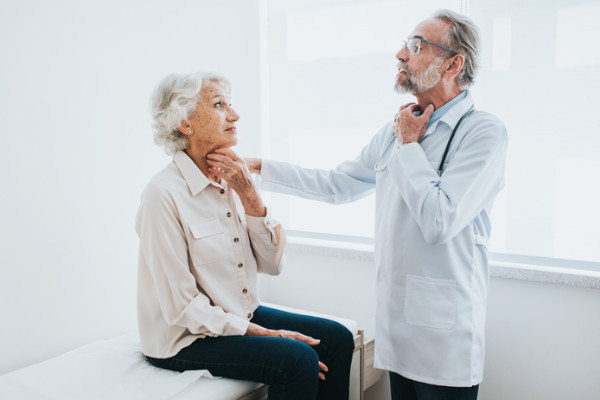 An ENT physician giving a patient an exam