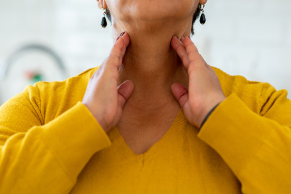 A woman rubbing her neck