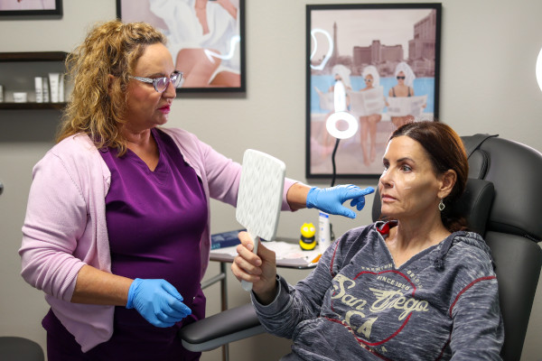 Joplin ENT's Ginnie Grimm showing a patient the result of their treatment