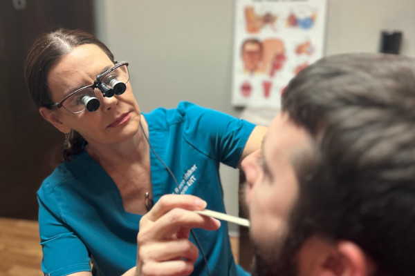 Dr. Walker of Joplin ENT performing a mouth/throat examination