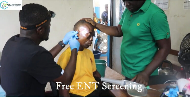 A Liberian man getting an ear exam by an ENT doctor
